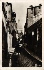 Carte postale ancienne Montmartre - La Rue Saint-Rustique - Au fond, le Sacré-Coeur
																	 à Paris 18e
								