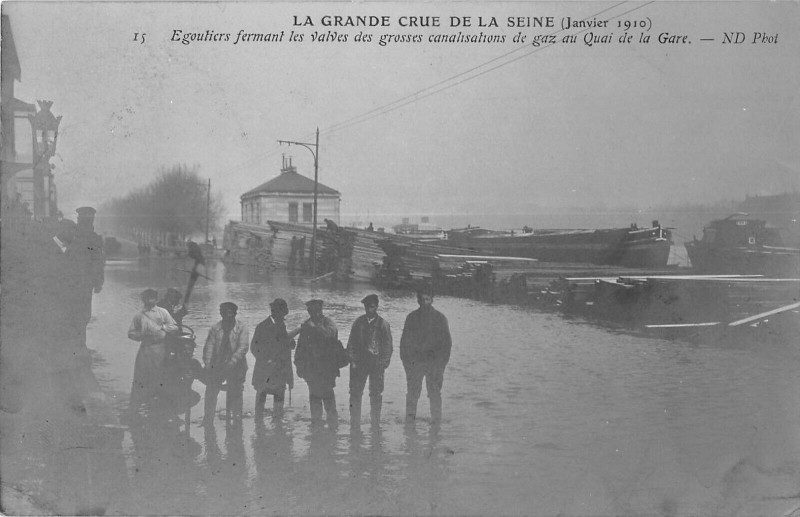 Carte postale ancienne La Grande Crue de la Seine (Janvier 1910) - Egoutiers fermant les valves des grosses canalisations de gaz au Quai de Ia Gare à Paris 13e
