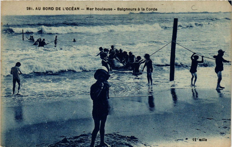Carte postale ancienne Au Bord de l'Ocean - Mer houleuse - Baigneurs a la Corde