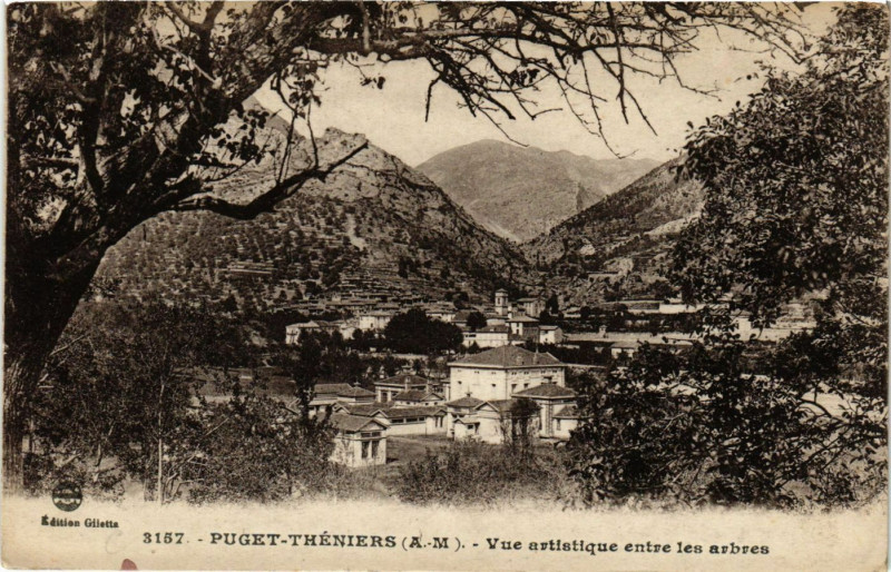 Carte postale ancienne Puget-Theniers - Vue artistique entre les arbres à Puget-Théniers