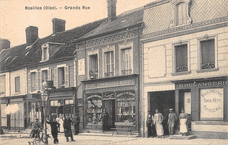 Carte postale ancienne Noailles - Grande Rue - Epicerie - Boulangerie à Noailles